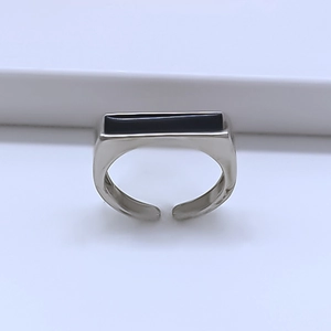 Detail of adjustable silver ring featuring a minimalist black rectangular inlay