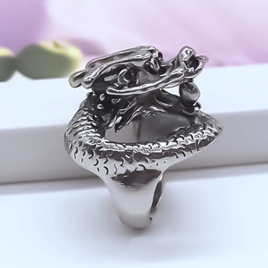 Detailed view of vintage silver dragon ring featuring intricate scales and adjustable band