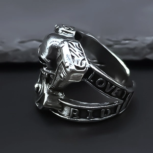 Macro shot of punk skull ring featuring mechanical engine detail and Love Ride engraving