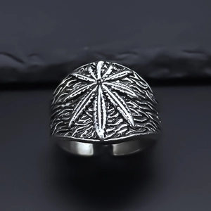 Macro shot of vintage silver alloy ring featuring an embossed maple leaf design