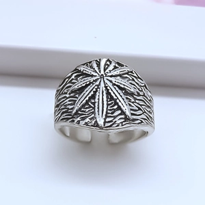 Detailed macro view of vintage silver wide band ring featuring maple leaf relief pattern