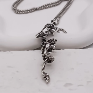 Vintage silver dragon pendant necklace with detailed scales and minimalist metal chain