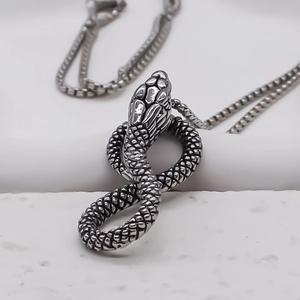 Vintage silver snake pendant necklace featuring intricate scales and a sturdy square bead chain