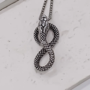 Detailed view of vintage silver snake pendant with intricate scale texture and chain