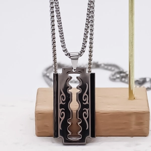 Hip hop razor blade pendant with tribal patterns on a steel box chain