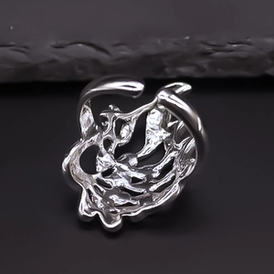 Detailed macro view of silver hollow peacock feather ring with vintage polished finish