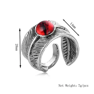 Vintage silver feather ring for men with a striking red eye stone and intricate details