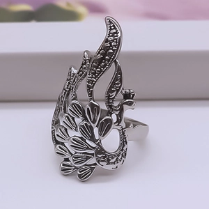 Close-up of vintage peacock ring with hollow carved feathers and oxidized finish