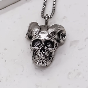 Macro shot of punk skull pendant with ram horns and dark oxidized vintage finish