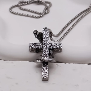 Vintage stainless steel serpent cross necklace with gothic hammered texture and detailed snake