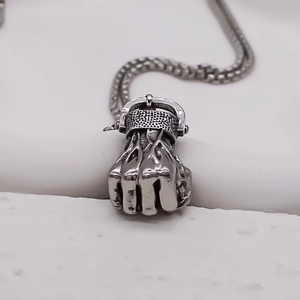 Punk style silver-toned fist pendant necklace with vintage texture and circular link chain