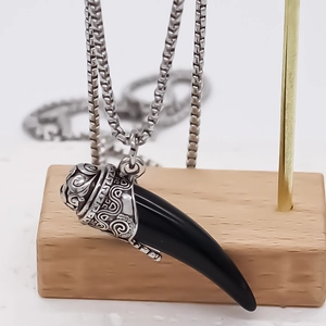 Men's stainless steel box chain necklace with black wolf tooth pendant in tribal style