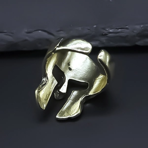 Detailed view of Spartan warrior helmet ring in vintage gold finish metal texture