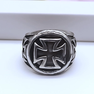 Macro detail of men's vintage alloy ring featuring an iron cross relief in gothic punk style
