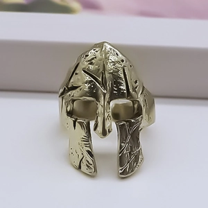 Detailed close-up of golden Spartan helmet ring with vintage distressed finish for men