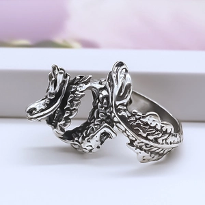 Macro shot of retro dragon ring showing detailed scales and textured silver finish