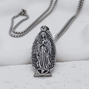 Detailed view of Gothic Virgin Mary and skull pendant on a silver box chain necklace