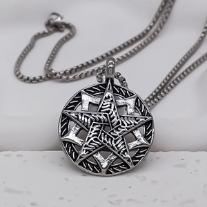 Macro view of vintage hollow circular pendant with engraved star and box chain details