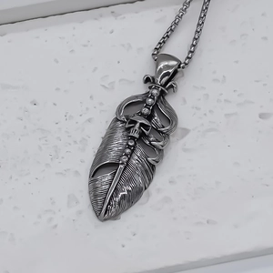 Vintage silver feather pendant necklace with skull detail and square box chain