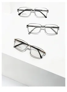 Three business style stainless steel square frame glasses displayed on a white staircase