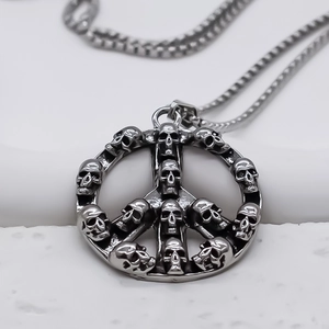 Macro view of vintage silver skeleton peace sign pendant on a square pearl chain