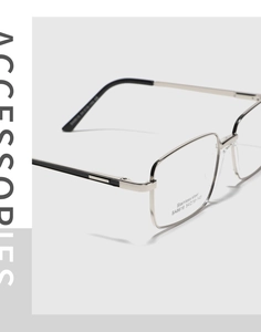 Macro shot of silver stainless steel eyeglass frames with striped temple details