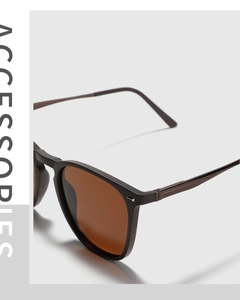 Detail of square TR90 sunglasses with brown polarized lenses and silver rivet accents
