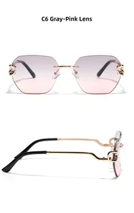 Detail view of grey pink gradient rimless sunglasses with C-shaped gold hardware