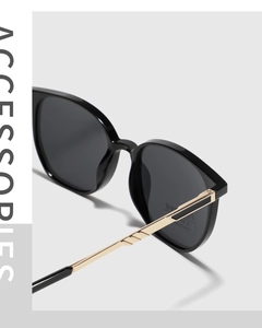 Detailed close-up of TR90 frame sunglasses with golden metal temples and UV400 lenses