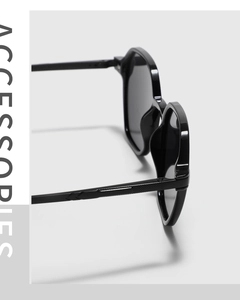 Detail view of durable screw hinges and non-slip textured temples on black square sunglasses