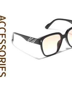 Detailed side view of black square sunglasses with gradient orange lenses and white temple patterns