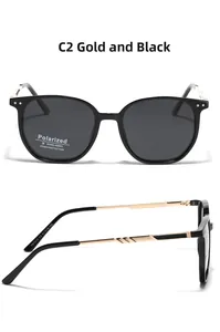 Detail view of square polarized sunglasses with black frames and golden metal temples