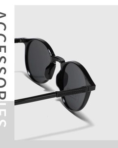 Close-up of black retro round TR90 sunglasses featuring textured lattice temples