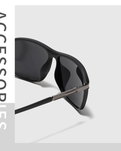 Detailed close-up of matte black square sunglasses featuring textured silver metal temple accents