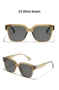 Detail view of olive green square sunglasses with metal star rivet and white stripe temple