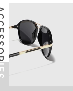 Detail of the TR90 sunglasses showing the polished black frame and gold metal temple joint