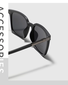 Macro view of detailed metal engraved hinges on black square polarized sunglasses