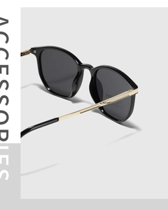 Close-up of golden metal temples with diamond texture and UV400 lenses on sunglasses