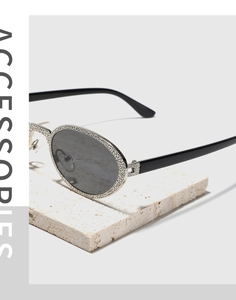 Makroansicht der ovalen Retro-Sonnenbrille mit silberner Hammerschlag-Metallfassung