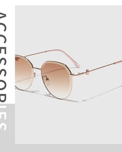 Macro detail of rose gold geometric sunglasses with gradient lenses and padlock charm