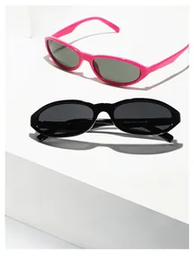 Detail shot of pink and black oval sunglasses showing model numbers on temple arms