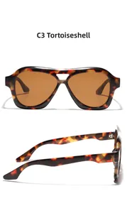Detail view of tortoiseshell double-bridge aviator sunglasses with brown lenses