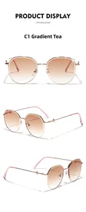 Detail view of round metal sunglasses with gradient tea lenses and rose gold slim frame