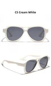 Detail view of double bridge square sunglasses in cream white finish with grey lenses