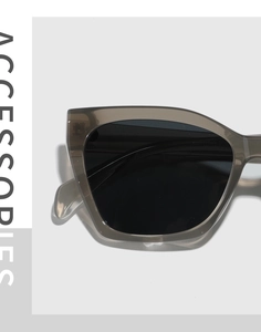 Detail shot of translucent taupe TR90 cat-eye frames and black polarized lenses
