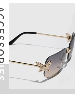 Close-up of butterfly metal hinge with rhinestones on rimless gradient sunglasses
