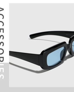Detailed close-up of wide black rectangular frames with light blue transparent lenses