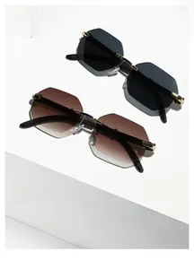 Detail of rimless octagonal sunglasses with gold metal bridge and gradient lenses