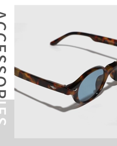 Detail of tortoise shell sunglasses with light blue lenses and silver hardware