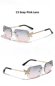Detail of rimless butterfly sunglasses with grey-pink gradient lenses and gold metal frame